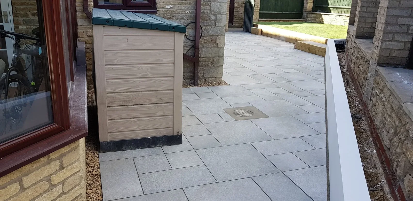 Completed side path leading past a garden storage shed to the rear garden